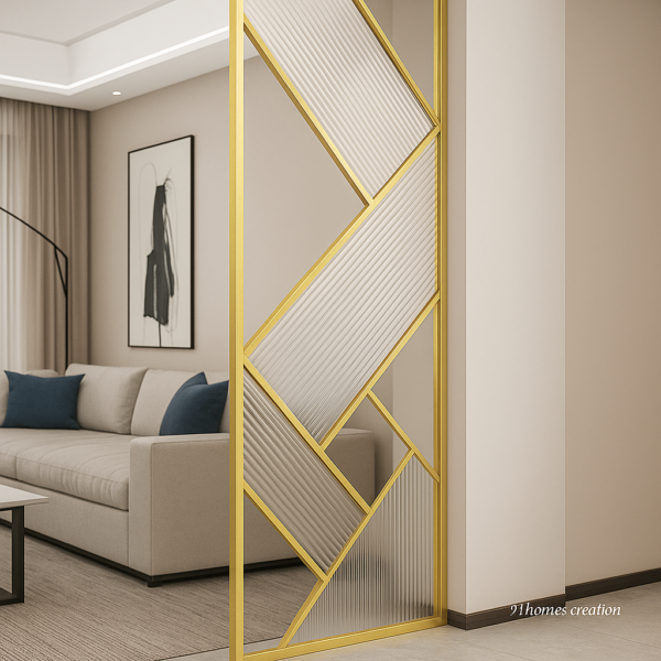 Contemporary metal partition with textured glass and golden finish, placed beside a grey sofa.