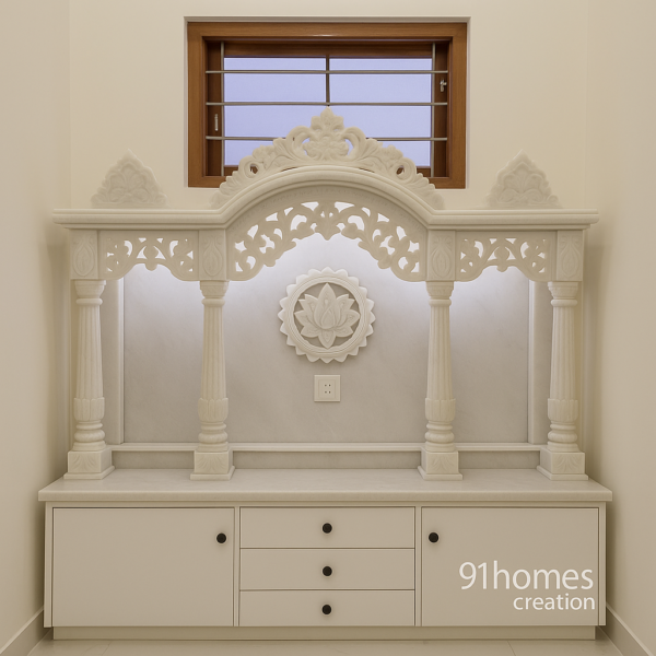 White marble mandir with carved arch and lotus motif design.