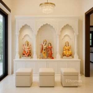 White carved mandir with Ganesha, Lakshmi, and Radha Krishna idols in arched niches