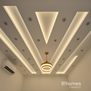 Modern white false ceiling with triangle cut-out and LED strip lighting