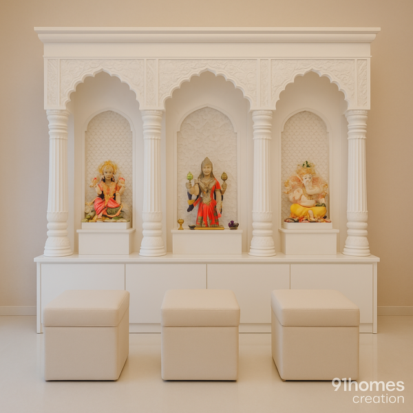 Traditional white marble temple with carved arches and deity idols