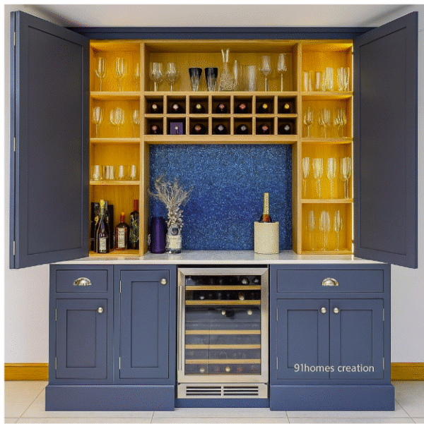 Side angle view of navy blue home bar with wine cooler and wooden shelves.