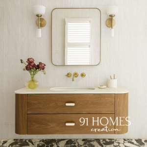 Modern wall-mounted wooden vanity with white marble countertop and brass fixtures.